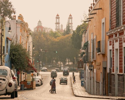 Morning street view in a Mexican city with people walking to work